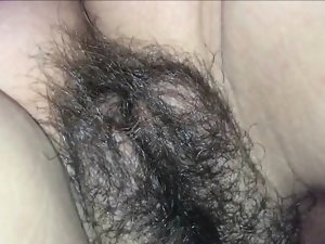 He releases his load upon her hairy vagina.