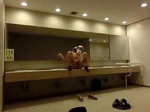 Naughty Asian stroking his cock in a public restroom