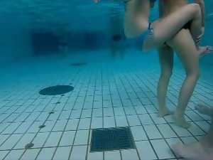 girsl underwater at pool 